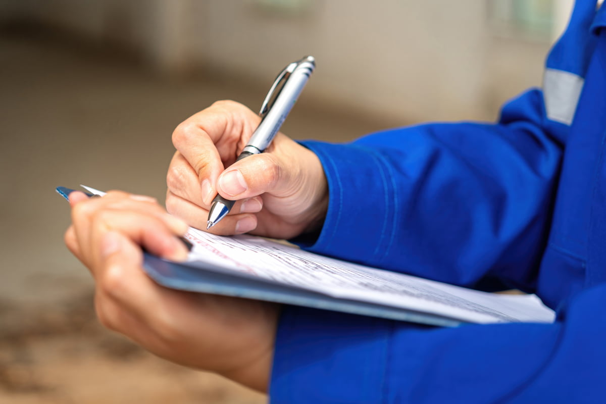 Inspector completing paperwork for structural repairs and certification.